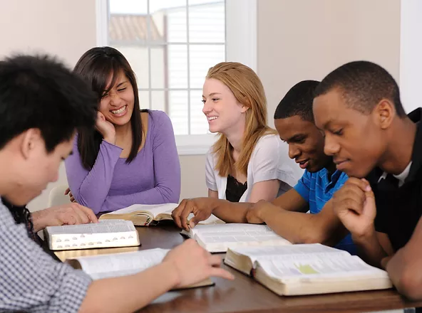 a group of young adults studying the Bible 